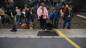 Members of The Seeing Eye Puppy Training Program and their dogs touring the amphibious assault ship USS Kearsarge (LHD 3)