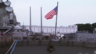 Musician plays Taps pierside of USS Fitzgerald (DDG 62)