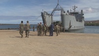 Logistics Marines unload vessel with heavy equipment on Hawaii