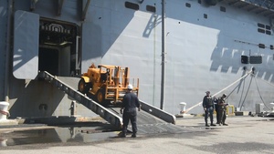 Equipment and supplies being onloaded to USS Iwo Jima in Norfolk in anticipation of tasking to support hurricane relief efforts