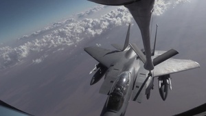 KC-135 refuels F-15s and A-10 fighters