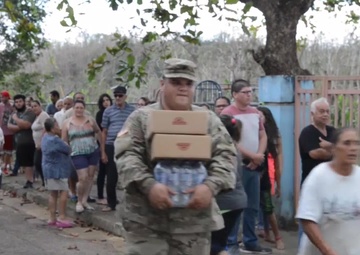 Coast Guard Investigative Service and Army personnel deliver aid to residents of hard-hit Puerto Rican neighborhoods