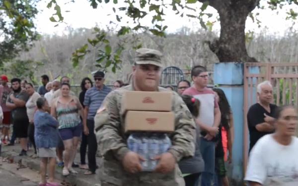 Coast Guard Investigative Service and Army personnel deliver aid to residents of hard-hit Puerto Rican neighborhoods