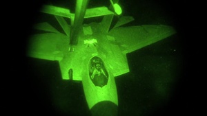 KC-10 refuels F-22 Raptors at night