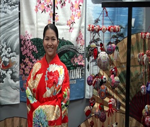 Service members try on kimonos in the Marine Lounge (Package/Pkg)