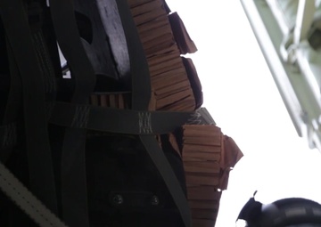 Alaska National Guard C-130J drops equipment, personnel to frozen Beaufort Sea