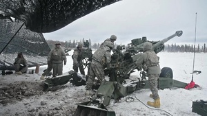 Soldiers fire a Howitzer during a live fire event