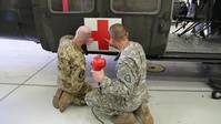 Alaska Guard Black Hawk helicopters welcome a red cross