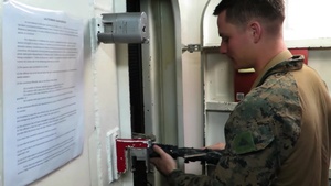 26th MEU Marines and 307th Naval Infantry Battalion draw weapons aboard the USS Oak Hill