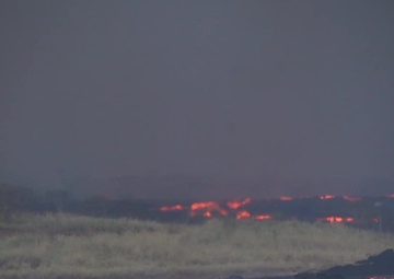 River of Lava Flows Down Valley in Hawaii