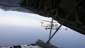 Marine C-130 refuels a CH-53 mid-flight during RIMPAC