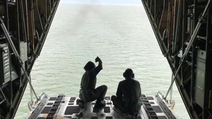 Coast Guard HC-130 crew drops message block to adrift skiff in Bering Sea