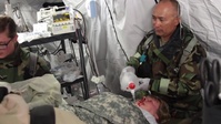 Army medical soldiers deal with organized chaos in mass casualty exercise
