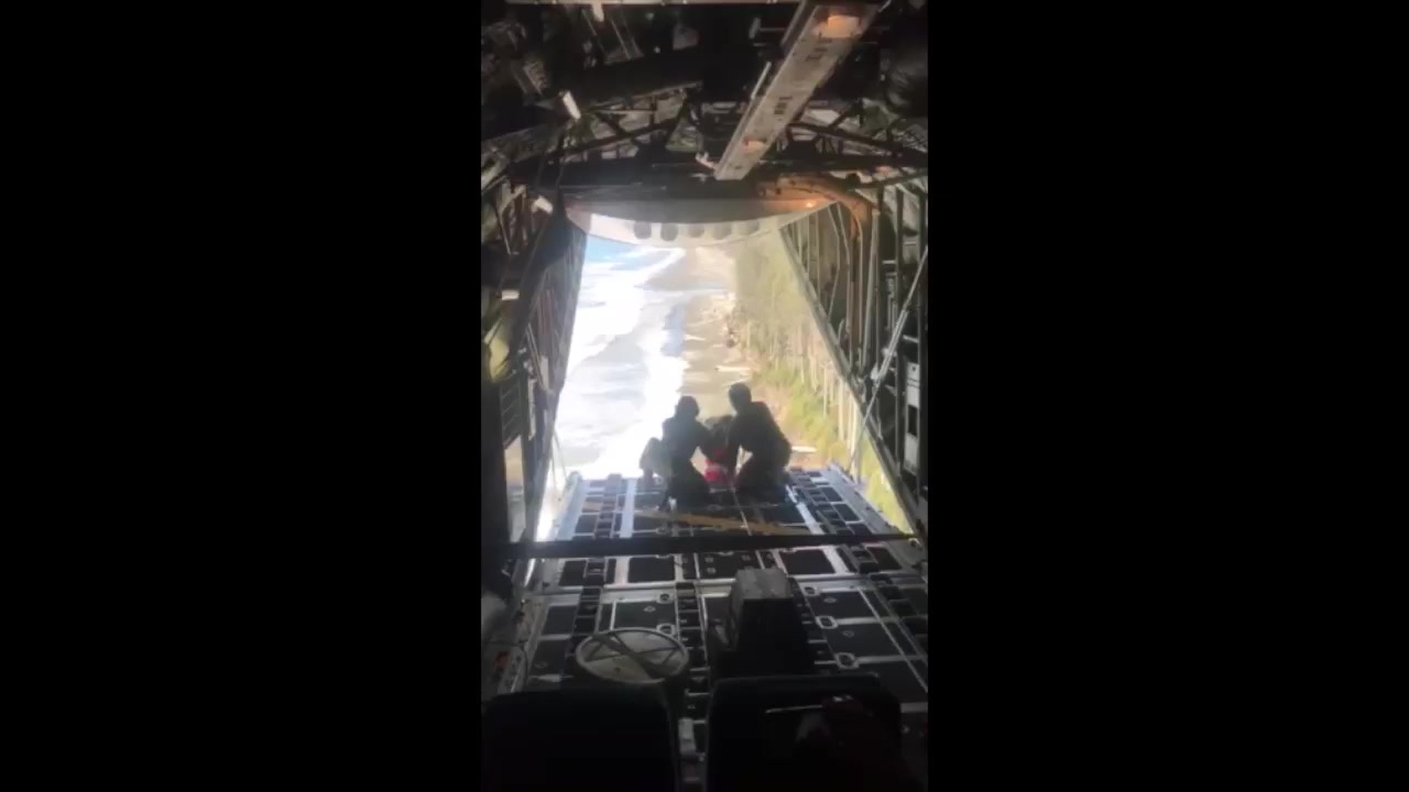 A Coast Guard Air Station Kodiak HC-130 Hercules aircrew works together to drop a rescue pack to a survivor stranded 127 miles east-southeast of Cordova, Alaska, Oct. 3, 2018. The man was later rescued from his grounded and disabled 40-foot fishing vessel, Gambler, through coordinated efforts of the Coast Guard and the Alaska State Troopers. U.S. Coast Guard courtesy video.