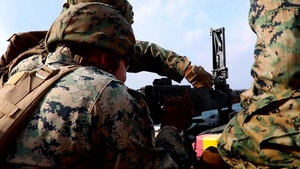 Weapons Company Marines fire machine guns aboard the Wasp