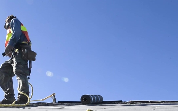 Construction Workers Seal Roofs Damaged by Hurricane Michael