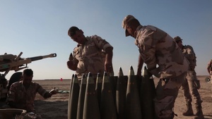 Iraqi soldiers fire artillery rounds
