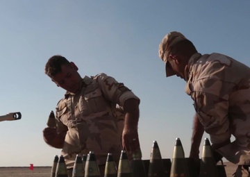 Iraqi soldiers fire artillery rounds