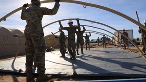 Soldiers and Airmen Construct Tents in Sunglow City (B-ROLL)