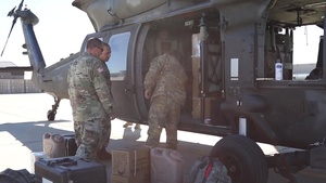 Soldiers Unload Equipment Out of UH-60
