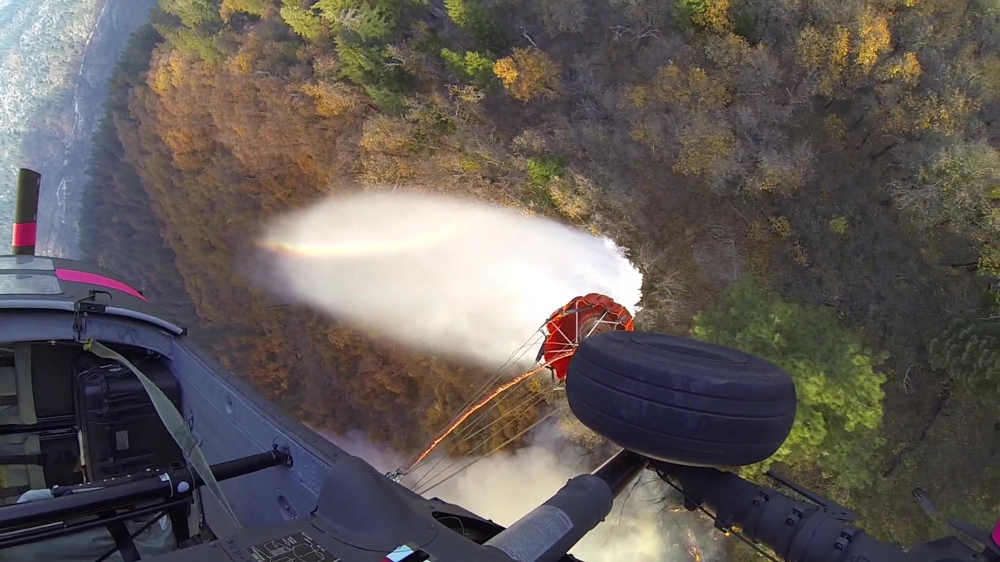 A UH-60M Black Hawk helicopter from the California Army National Guard&#39;s 1st Assault Helicopter Battalion, 140th Aviation Regiment, drops buckets of water on the Camp Fire in Butte County, California, Nov. 14, 2018. Includes cockpit audio and helmet footage looking out of helicopter over drop. Video captures the first water bucket flight for Cal Guard&#39;s new M-model UH-60s. (Video courtesy California Department of Forestry and Fire Protection [CAL FIRE])