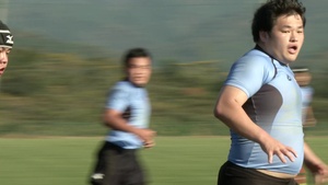 MCAS Iwakuni service members form up with their Japanese teammates for the game of rugby (B-Roll)