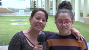 USAF Sgt. Maria Ferrer and daughter give a holiday shout out from Kadena Middle School.