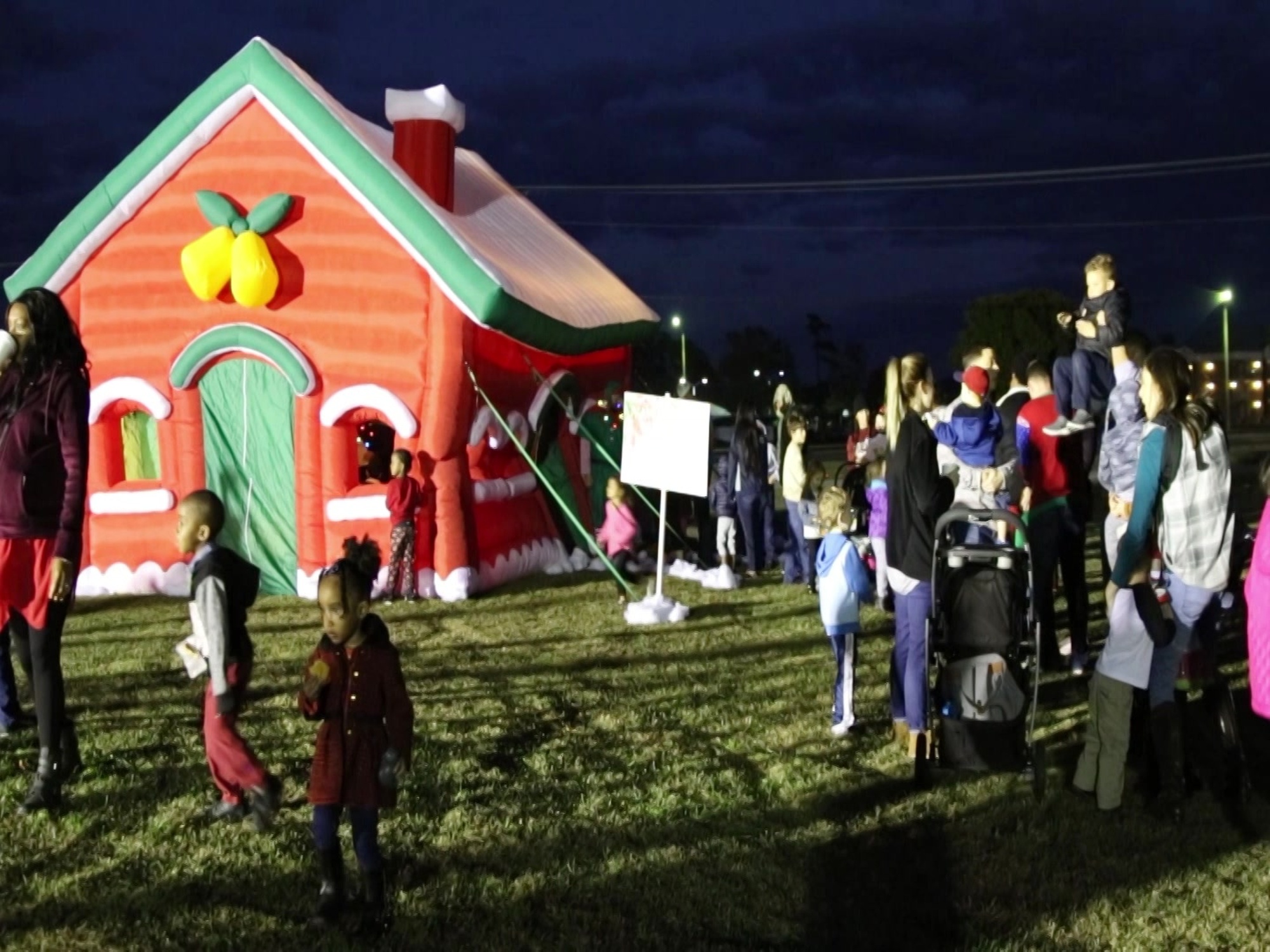 Families gather for the 19th annual Christmas tree lighting ceremony at Marine Corps Air Station Cherry Point, N.C., Nov. 30, 2018.  Among the Christmas lights, elves and holiday spirit in the air, the 2nd Marine Aircraft Wing Brass Band provided live music throughout the festivities. The celebration included activities such as a Christmas themed beanbag toss, holiday selfie station, a holiday cookie making station and reindeer antler ring toss. Santa Claus even made a special appearance for the children to come and tell him their Christmas wish list. This celebration is an event hosted by Marine Corps Community Services every year to kick off the Christmas spirit by bringing families together during the holiday season.