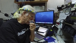 B-Roll of Bruce Best, volunteer Island liaison/ radio operator for Operation Christmas Drop