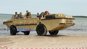 U.S. Marines and Romanian marines secure a beach after disembarking from the Lubin-class mine layer landing ship, ORP Gniezo, during exercise Baltic Operations (BALTOPS) 2019 at Kallaste, Estonia June 12, 2019.