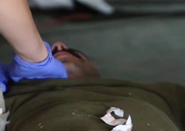 Soldiers of the 928th MCAS and Marines of CLR 45, Landing Support Detachment 1, conduct a mass casualty training exercise during Northern Strike 19