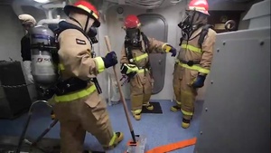 Sailors participate in a damage control firefighting training evolution at sea aboard USS John P. Murtha (LPD 26).