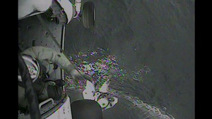 Rescue crew from Air Station hoists fisherman in life raft