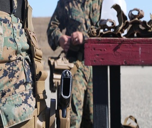 Marines participate in a pitol qualification course.