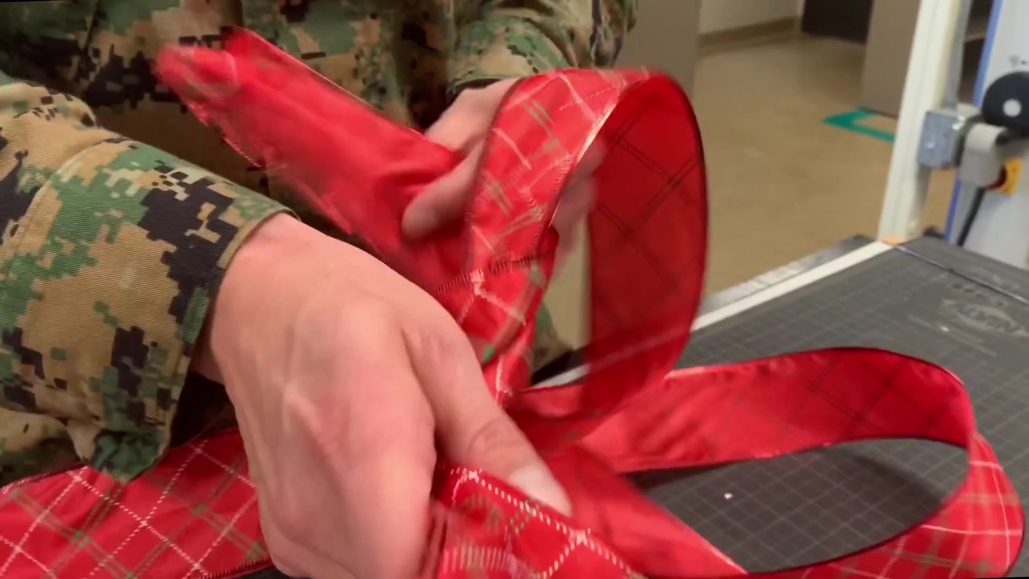 Warrant Officer Zachary Dyer a production officer, Communication Strategy and Operations, Headquarters and Support Battalion, Marine Corps Installations- West, wraps a present on Camp Pendleton, December 19, 2019. Base COMMSTRAT wishes everyone a Merry Christmas and Happy Holidays. Dyer is a native of Phoenix, Arizona. (U.S. Marine Corps video by Lance Cpl. Kerstin Roberts)