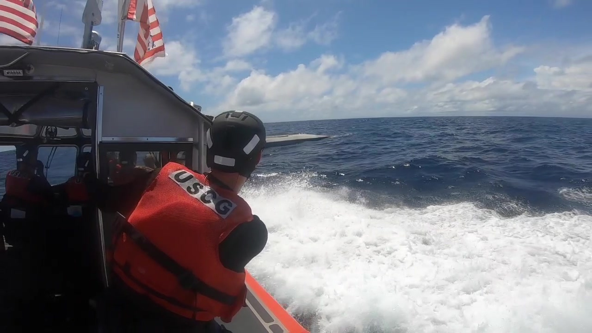 Crew members from the pre-commissioned Coast Guard Cutter Midgett (WMSL 757) interdict a suspected low-profile go-fast vessel in international waters of the Eastern Pacific Ocean while transiting to their future homeport in Honolulu, July 31, 2019. The crew seized more than 4,600 pounds of cocaine from the suspected drug-smuggling vessel. U.S. Coast Guard video.