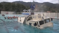 Assault Amphibian School students take a ride in the Submerged Vehicle Egress Trainer