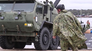 U.S. Marines and Sailors offload tactical vehicles from improved Navy lighterage system