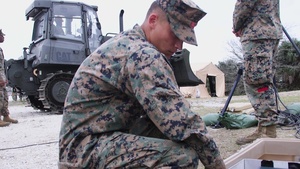 U.S Marines and Sailors unload containers off the improved Navy lighterage system at MPFEX20