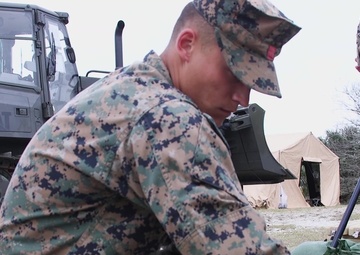U.S Marines and Sailors unload containers off the improved Navy lighterage system at MPFEX20