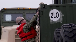 U.S Marines and Sailors unload heavy equipment off the Improved Navy Lighterage System at MPFEX20