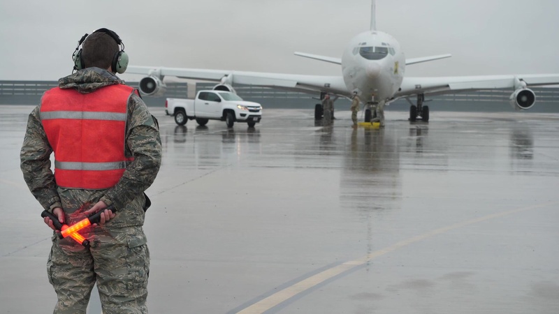 B-Roll - E-8C Joint STARS maintainers and flight crew Airmen brave rain to meet mission readiness