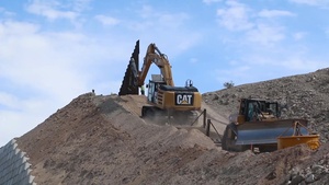 Pulling barrier panels uphill