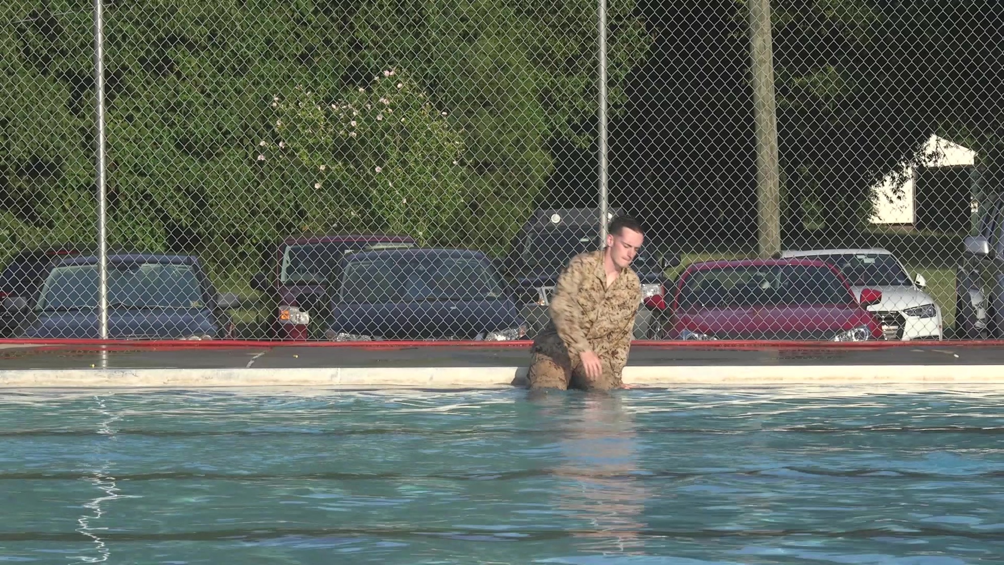 Perform a slide-in entry.
o	Sit down at the edge facing the water. 
o	Lower body into the water feet first.
o	Begin swimming approach.