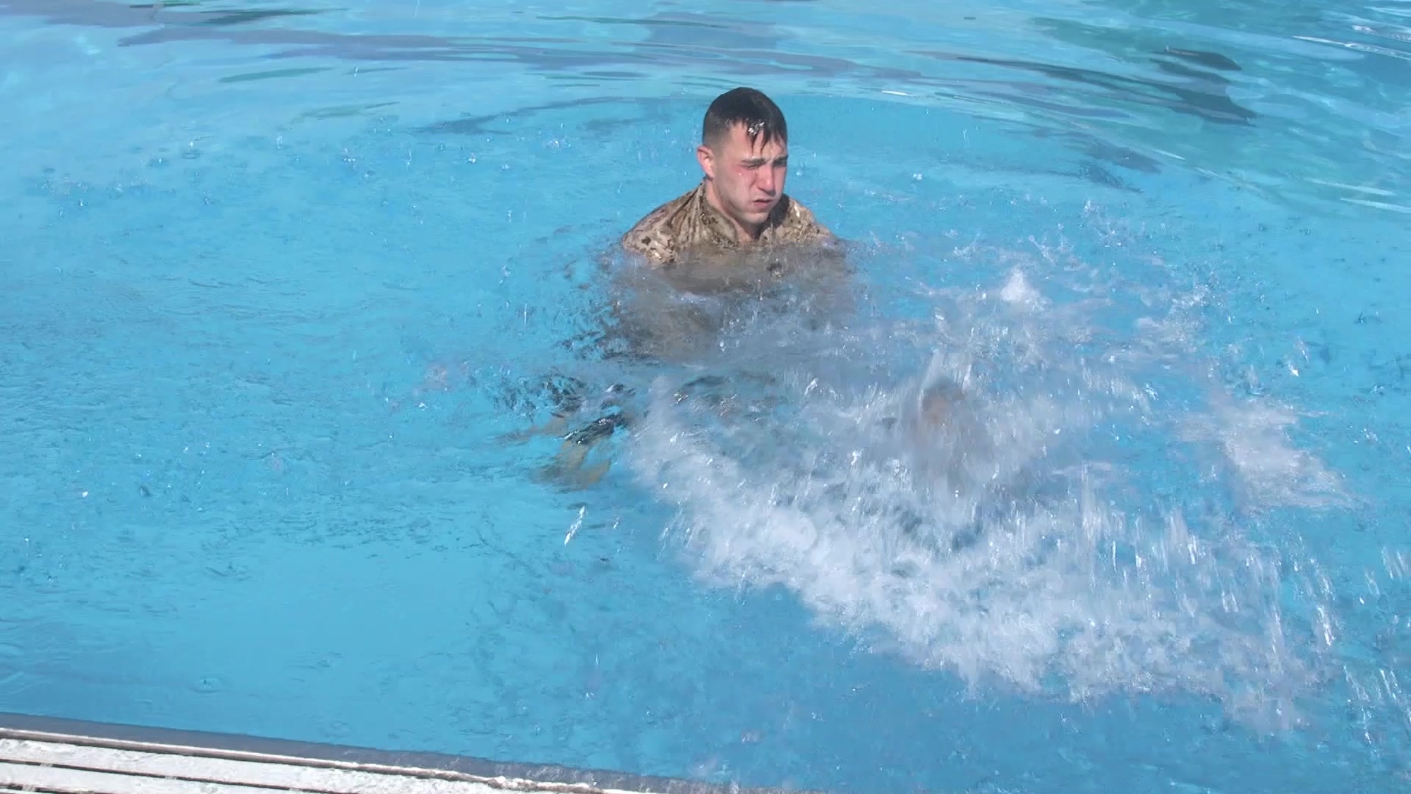 Given an aquatic environment with deep water, while wearing a combat uniform. 
o	Take a deep breath, bend over and remove boots 
o	Retain your boots. Tie the boot laces together and suspend the boots from your blouse or hang them around your neck so that they rest on your chest.
o	Remove your trousers. Button the trousers’ fly closed. This allows to control airflow.
o	Tie the bottom of your trouser legs in a square knot.
o	Hold the trousers above the water’s surface and behind your head. Grasp both sides of the waistband and open with both hands
o	Kick strongly to stay on top of the water while slinging the trousers overhead in order to trap air into them.
o	Once the waistband is submerged in the water, air is trapped in the legs.
o	Hold and seal the waistband underwater.
o	Slip the inflated legs over the head and hold the waistband in towards the chest.