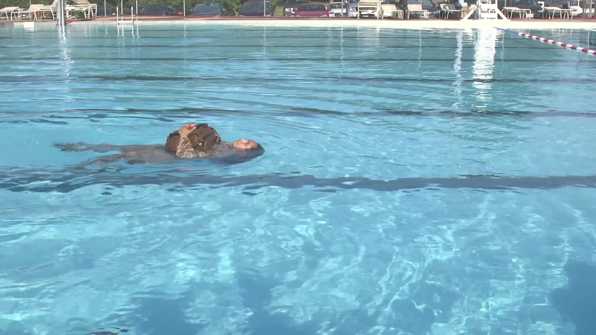 Given an aquatic environment, using a properly waterproofed pack with a full combat load, while wearing combat uniform.
If you are more efficient or comfortable swimming on your back, hug the pack to chest, turn the back to the direction of travel. Keeping the boy horizontal and face up, utilize a kick that propels you best. Inverted breast-stroke is the preferred kick. If you find difficult to propel yourself with your boots on, you may use flutter kick or simulate a backward stepping action with your legs
The videos are part of a how-to series for completion of the exit skill events in each level of the Marine Corps Water Survival Program (MCWSP). Video 2 of 5.