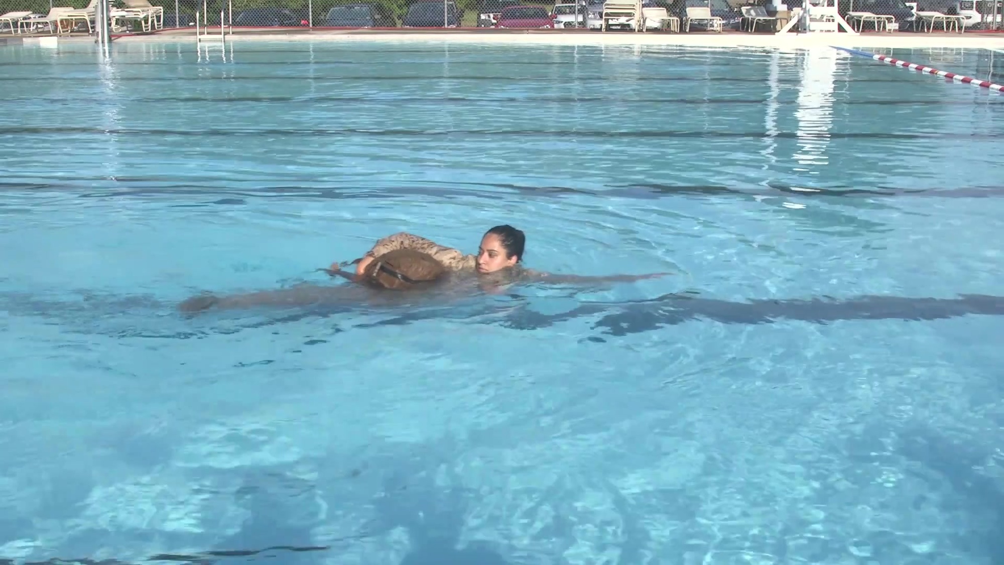 Given an aquatic environment, using a properly waterproofed pack with a full combat load, while wearing combat uniform.
If you are comfortable swimming on your side and want extra propulsion, hold the pack to hip with top arm, reach out with the lead arm under water collapsing your elbow to pull against the water with your hand. Utilize scissor kick. 
The videos are part of a how-to series for completion of the exit skill events in each level of the Marine Corps Water Survival Program (MCWSP). Video 2 of 5.