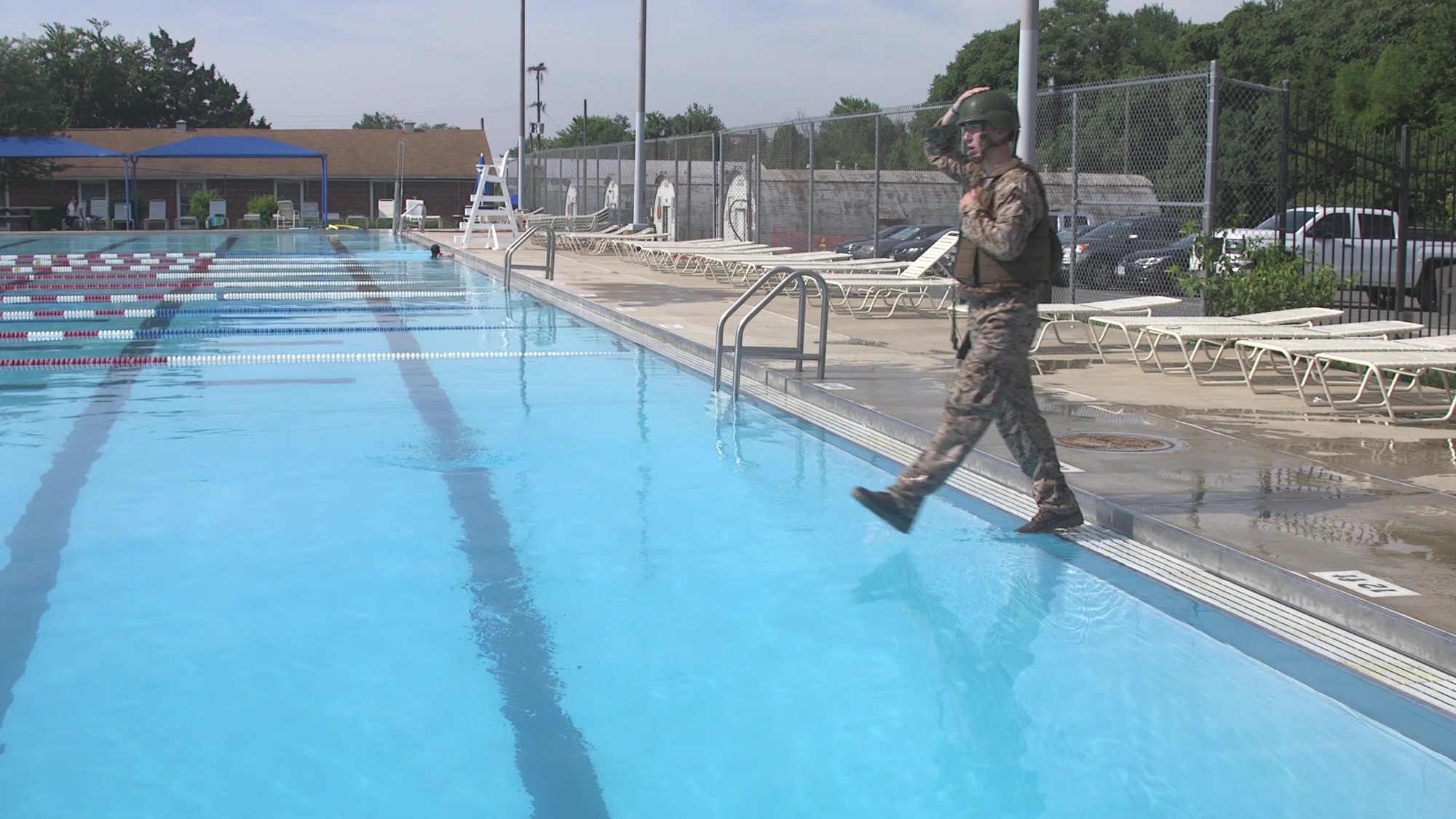 Given an aquatic environment with deep water, while wearing a combat uniform with full combat load.
o	Place hand on top of helmet and other hand securing riffle to body.
o	Step off the side with a smooth a 30 inch stride. 
o	Once underwater remove the combat load.
o	Surface and exit the water.