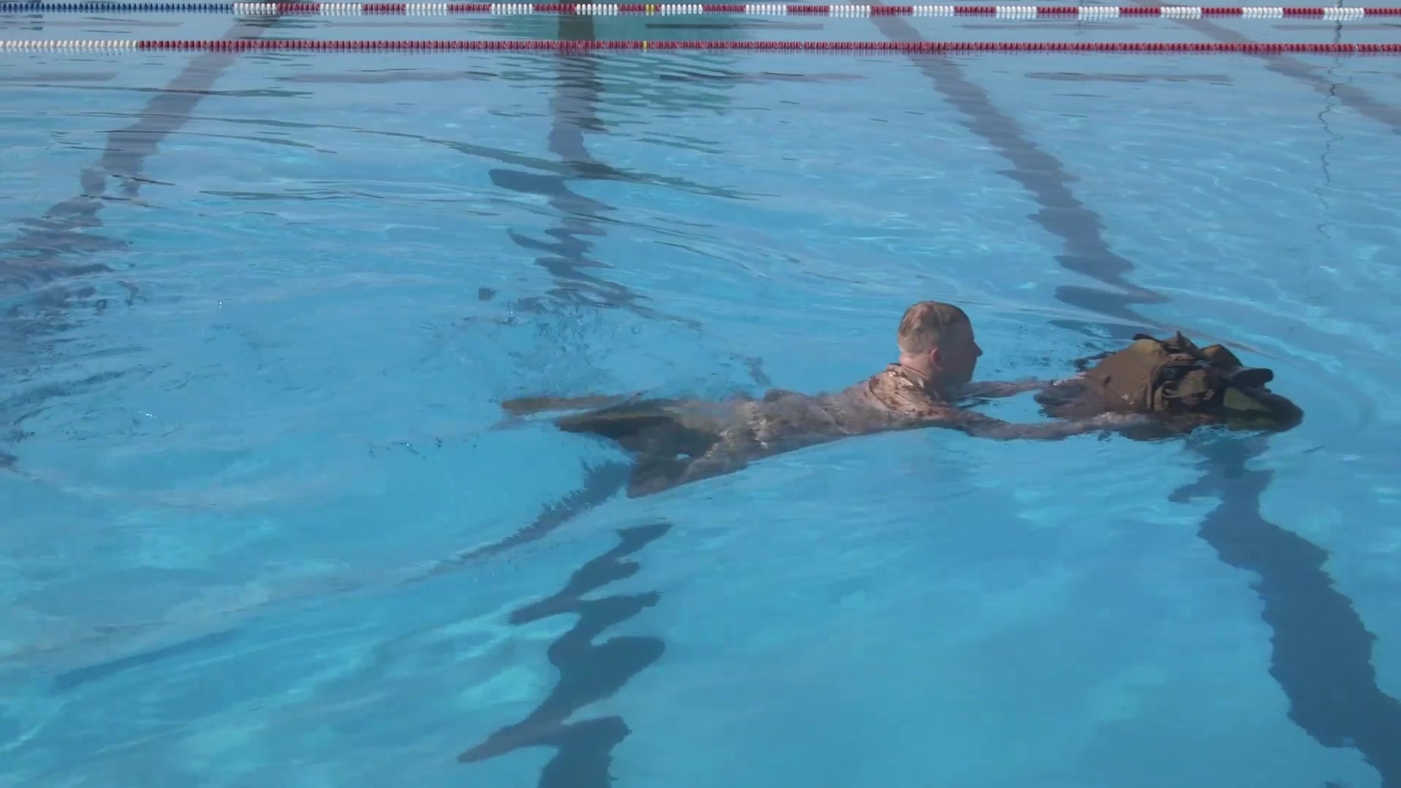 Given an aquatic environment, using a properly waterproofed pack with a full combat load, while wearing combat uniform. Swim 25 meters in deep water pushing or towing the gear maintaining contact with ger at all times. Pack retention methods: On the pack, under the pack, pack on the side and reverse pack travel.