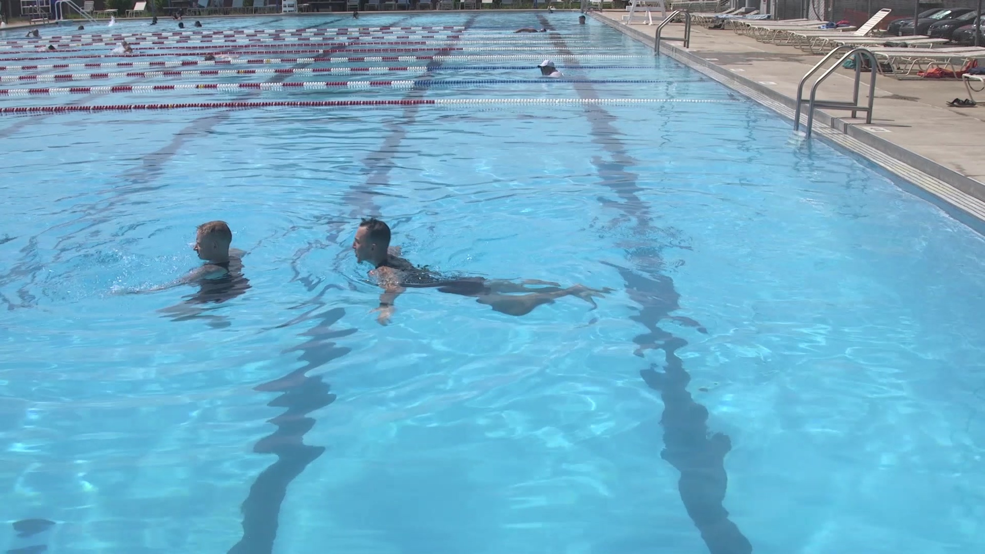 Approach the victim slowly and grab the armpits with both hands. Place the elbows on the victim’s back. Pull with the hands that are in the victim’s armpits while pushing with the elbows that are in the victim’s back and use an inverted breast stroke kick to place the victim horizontal on the water’s surface (face up).